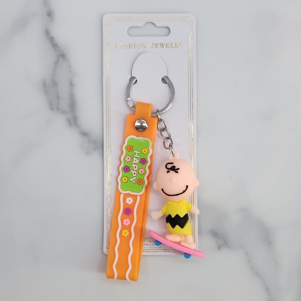 Peanuts Charlie Brown Skateboarding 3D Figure Keychain, "HAPPY" Strap Bag Charm